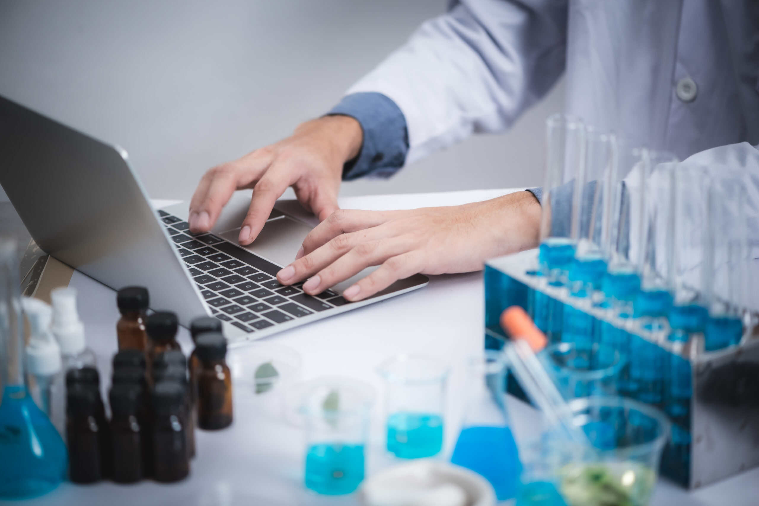 Clinician reviewing clinical research website design mockup on computer – CuraAd Marketing Group